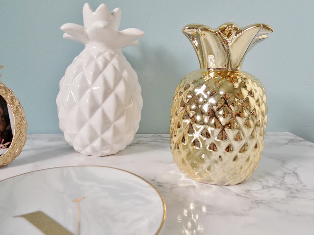Gold pineapple homeware and marble background