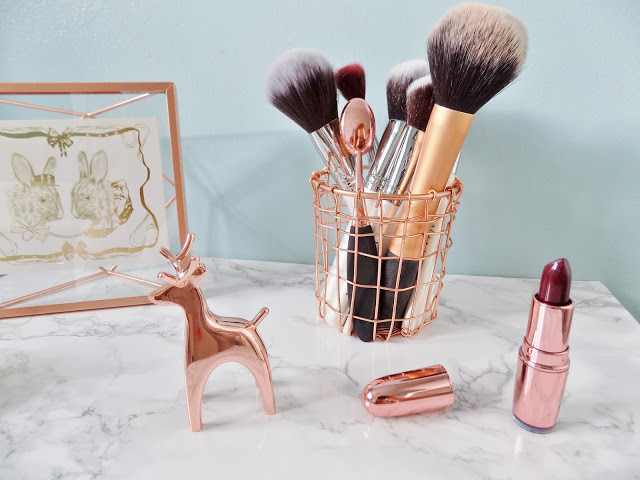 Copper Homeware accessories make up brush pot with marble background